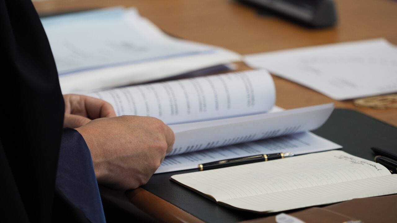 Photo of a Judge studying a case file
